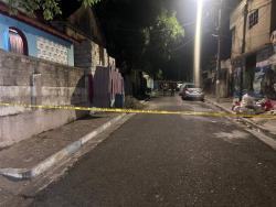 Police investigators at the scene of Tuesday night’s shooting in Kingston.