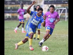Credit: Ashley Anguin Cambridge High’s Odane McKayle (left) tries to outrun Rusea’s High’s Jerome Darling during their Zone B football match in the ISSA daCosta Cup competition at Jarrett Park in Montego Bay, St James, yesterday. Rusea’s won 2-1.