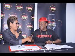 Shake on it! Erin Mitchell (left), head of consumer marketing at Wisynco, and Marlon ‘Boom Boom’ Wizard sign the contract, certifying the selector as Boom Energy Drink Global Ambassador on Wednesday.