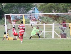 Credit: Nathaniel Stewart Glenmuir High School’s Orane Watson (second left) scores the opening goal during their Zone I ISSA WATA daCosta Cup football match against Garvey Maceo at Glenmuir High School on Wednesday. Garvey came from behind to win 3-2.