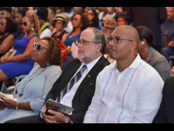 Credit: Antoine Lodge From left: Minister of of Culture, Gender, Entertainment and Sport Olivia ‘Babsy’ Grange; Leader of the Opposition, Mark Golding; and Member of Parliament for Manchester North Western Mikael Phillips watch proceedings at the thanksgiving service for Allan ‘Skill’ Cole at the National Arena on Saturday.