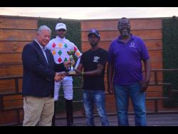 Jockey Reyan Lewis, after riding UNSPUN to victory, looks on as connections receive the TYPEWRITER Trophy at Caymanas Park on Sunday, September 28.