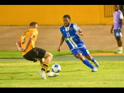 Jon Trincado Velasco (left) of O&M tries to block the path of Alex Marshall of Mount Pleasant during their Concacaf Caribbean Cup Match at the National Stadium on September 30, 2025