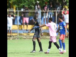 Credit: Ashley Anguin Kemps Hill High School’s goalkeeper Omario Chambers (centre) gesticulates as he argues with referee Obrian Warren (left) during the ISSA WATA daCosta Cup round-of-16 football match against St Elizabeth Technical High School (STETHS) at STETHS yesterday. Looking on is Kemps Hill’s Orlando Campbell. STETHS won 4-0.