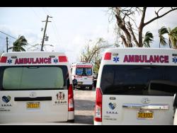 Numerous ambulances wait for the clearing of Lacovia main road to continue on to Black River.