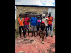 Contributed
Kevin ‘Biggaton’ Roye (second right) and other residents are helping to rebuild the home of neighbour Denton (third left), who is blind.