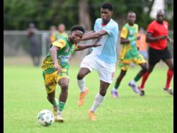 Kimarly Scott of Excelsior High School (left) is challenged by Kevaughn Brown of St George’s College during their ISSA WATA Manning Cup football match at Winchester Park, St. George’s College on Saturday, October 11.