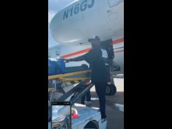 Hollywood actor and singer Tyrese Gibson helps to offload the supplies after landing in Jamaica with his team yesterday.