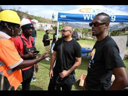 Credit: Photos by Ricardo Makyn/Chief Photo Editor Dancehall artiste Sean Paul (second right) and Chef Brian Lumley (right) engage with community organisers in Beeston Spring, Westmoreland, during ongoing relief efforts for victims of Hurricane Melissa.