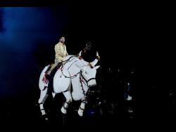 Tollywood superstar Mahesh Babu rides a mechanical bull at the unveiling of first look of film “Varanasi” in Hyderabad, India, on Saturday.