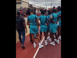 Credit: Raymond Graham Coach Winston Nevers (left partially hidden) of Denbigh High gives instructions to his team during half-time break in their top of the table ISSA rural under-16 clash with Glenmuir High yesterday at Glenmuir.
