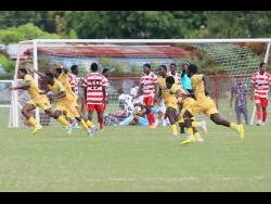 Credit: Nathaniel Stewart Garvey Maceo High School players celebrate scoring the winning goal during their ISSA daCosta Cup football match against Glenmuir High at Glenmuir High School on Wednesday, October 8. Garvey Maceo won 3-2.