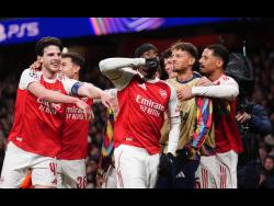 Arsenal’s Noni Noni Madueke (centre) celebrates after scoring his side’s second goal during the Champions League opening phase soccer match between Arsenal and Bayern Munich in London, Wednesday, Nov. 26, 2025. 