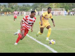 Credit: Nathaniel Stewart Garvey Maceo High’s Tyreek McKenley (right) challenges Orel Miller of Glenmuir High during their Zone I, daCosta Cup football match at Glenmuir High School earlier this season. Garvey Maceo came from behind to win 3-2.