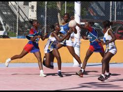 Netballers from Camperdown High (red and blue tops) and Gaynstead High battle for the ball during an ISSA urban area match at the Leila Robinson Court in November 2024.