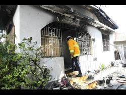 Firefighter at the scene of a house fire along Mountain View Avenue 