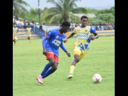 Credit: Ashley Anguin Kemps Hill High’s Shaventy Knight (left) and St Elizabeth Technical High’s (STETHS) Kaieem Lewis battle for the ball during their opening match of the round of 16 of the ISSA daCosta Cup at STETHS Sports Complex on Wednesday, October 22, 2025.