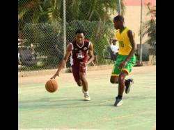Credit: Ashley Anguin Herbert Morrison Technical High’s Ryan Jurdine (left) works his way around Ocho Rios High’s Matthew Smith during their ISSA schoolboys basketball match at Herbert Morrison court on Monday, December 15, 2025.