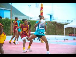 A pass intended for Jadionna Henry (centre) of Holmwood Technical is intercepted by Arianna Agate of Debigh High during the ISSA rural netball junior final at Leila Robinson Courts, Kingston, on Thursday, December 11.