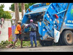 An NSWMA crew clearing up a Kingston community shortly after the passage of Hurricane Melissa.