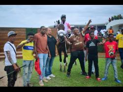 INTRESTINTIMESAHEAD, with Anthony Allen aboard, parades with connections in the winners’ enclosure after landing the third running of the WILL IN CHARGE Trophy at Caymanas Park on Sunday.