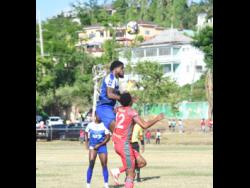 Mount Pleasant Football Academy’s Raheem Edwards (centre) jumps to head the ball while being challenged by Montego Bay United’s Timar Lewis (right) during their Jamaica Premier League football game at Jarrett Park on Sunday.