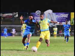 Odane Murray (left) of Molynes United FC and Waterhouse FC’s Revaldo Mitchell compete for possession of the ball during the Jamaica Premier League football match at Waterhouse Mini Stadium in St Andrew on Sunday. Molynes won 2-0.