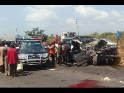 In this photo provided by the Federal Road Safety Corps, people gather at the accident scene of British boxer Anthony Joshua in Lagos, Nigeria, on Monday.