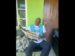 Algon Johnson reading a copy of THE STAR.