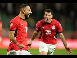 Egypt’s Mohamed Salah (left) celebrates after scoring his team’s third goal against Benin during their Africa Cup of Nations round-of-16 football game in Agadir, Morocco, on Monday. Egypt won 3-1.