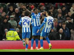 Brighton’s Danny Welbeck (centre) celebrates after scoring during the FA Cup third-round match between Manchester United and Brighton in Manchester, England, yesterday.