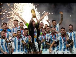 Argentina’s Lionel Messi lifts the trophy after winning the World Cup final  between Argentina and France at the Lusail Stadium in Lusail, Qatar, on December 18, 2022. 