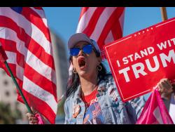 Maribel Gonzalez celebrates outside Versailles Cuban Cuisine after President Donald Trump announced President Nicolás Maduro had been captured and flown out of Venezuela.