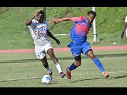 Shamar Watson (left) of Cavalier dribbles away from Nevaun Turner of Dunbeholden during their Jamaica Premier League match at the Stadium East field yesterday. Cavalier won 5-1.