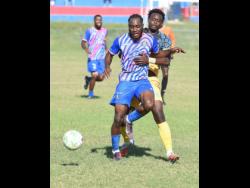 Credit: Ian Allen Akeem Mullings of Portmore United is challenged for the ball by Chavany Willis (right) of Racing United during their Jamaica Premier League football match at Ferdi Neita Park on Sunday.