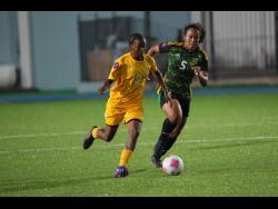 Credit: Courtesy of concacaf.com Aruba Under-17’s Zyana Rogers tries to elude Jamaica’s Phylicia Brown during a Concacaf Women’s U17 qualifier at the Stadion Guillermo Prospero Trinidad on Tuesday.