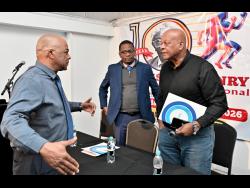 Leroy Cooke (left), chairman of the Local Organising Committee of SW Isaac-Henry Track and Field Invitational meet, chats with Dr Worrell Hibbert (centre), principal of St Andrew Technical High, and Brian Smith, JAAA executive member, at the launch of the SW Isaac-Henry Track and Field Invitational meet at the S Hotel in New Kingston yesterday.