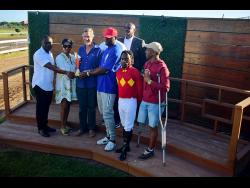 Winning connections of PACK PLAYS, including jockey Christopher Mamdeen (second right) at the presentation of the Eileen Cliggott Memorial Trophy, ran over six-and-a-half furlongs, at Caymanas Park on Saturday.