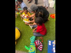 Principal Angela Panis playing with children.