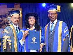 Sharing in the proud moment with Dr Carlene Davis-Cowan (centre) are Ambassador Lloyd Carney (left), chancellor of UTech, Ja, and Dr Kevin Brown, president.