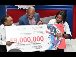 Terry-Ann Graver (right), COO of First Global Bank; and Tammara Glaves-Hucey (left), Managing Director of GK General Insurance present their company’s sponsiorship commitment to Keith Wellington, president of ISSA, at the launch of the ISSA Grace Shield and ISSA Grace Headley Cup cricket competitions, which are powered by First Global Bank and GK General Insurance, at Grace Foods Multi-Function Room on Harbour Street, Kingston, on Thursday.
