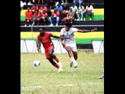 Montego Bay United’s Kimani Arbouine (left) tries to outrun Cavalier SC’s Michael Forbes during their Jamaica Premier League football game at Jarrett Park in Montego Bay on Sunday. MoBay United won 1-0.