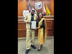 Vybz Kartel (left) receives his citation from Mayor of Lauderhill Denise Grant.