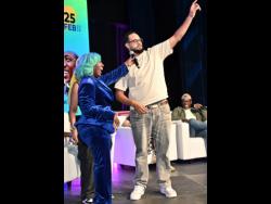 1Clauze shares the moment with host Spice during the Island Music Conference at the Courtleigh Auditorium in New Kingston.