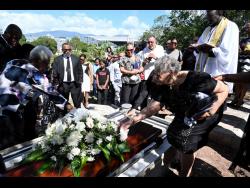 Mourners lay flowers on the casket of Melissa Silvera at her funeral in 2024.