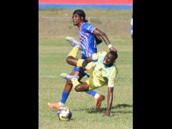 Jesus Gudino (front) of Waterhouse FC is fouled by Javier Brown of Portmore United during their Jamaica Premier League football match at the Ferdi Neita Sport Complex on Thursday. Waterhouse won 1-0.