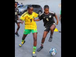 Under-17 Reggae Girl Shaniel Buckley (right) is challenged by Ricquanna Richards during a mock session at the Jamaica Football Federation in July, 2023. Both are key members of Jamaica’s Under-17 team. 