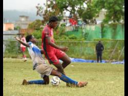 Montego Bay United’s Malachi Sterling (right) is slide-tackled by Dunbeholden FC’s Jovan Gordon during their Jamaica Premier League football game at Jarrett Park in Montego Bay on Wednesday. Montego Bay United won 4-3.