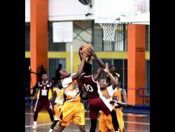 Credit: Antoine Lodge Andra Morgan of Manchester High School (left) stops Antonio Kerr of Herbert Morrison High from shooting during the ISSA rural basketball under-16 finals at G.C. Foster College of Physical Education and Sport in Angels, St Catherine, on Thursday.