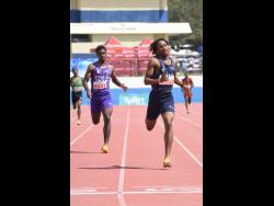 Omary Robinson (right) from Jamaica College winning heat one of the boys’ Class One 400 metres in 46.93 seconds ahead of Jordan Rehedul of Kingston College, in 47.89 seconds, during the Corporate Area High School Track and Field Athletics Championships at the Ashenheim Stadium.